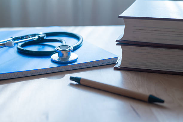 Medical Notepad And Stethoscope On Doctor’s Desk In Hospital, Emphasizing Professionalism And Patient Health Care