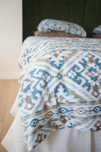 istock A Cozy Bed Featuring a Stylish Geometric Blanket and Decorative Pillows 2206693229