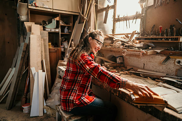 istock Female carpenter sanding wood in workshop 2206693334