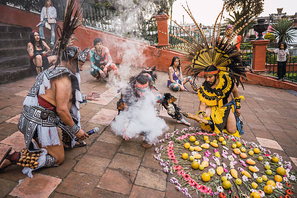 Dancers in pre-Hispanic costumes perform their ritual dance to welcome spring during the New Fire Ceremony, lighting their torches for the ceremony on the Steps of Calvary in Metepec, State of Mexico.