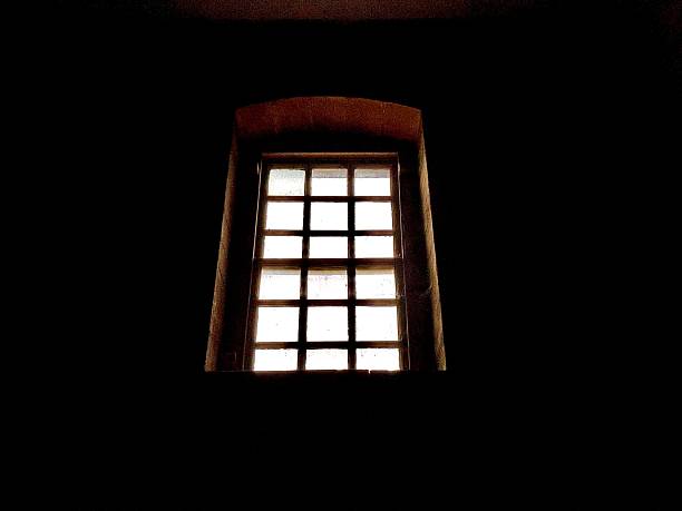 istock An ancient window letting light into a dark room 2206695182
