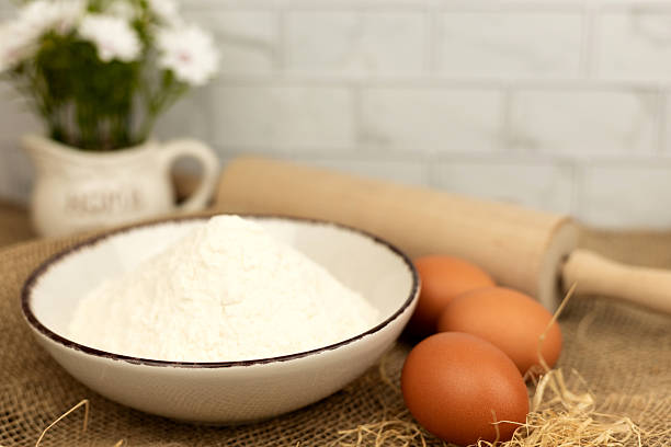 istock Baking products - flour, eggs. Flour and eggs on the table close-up 2206695589