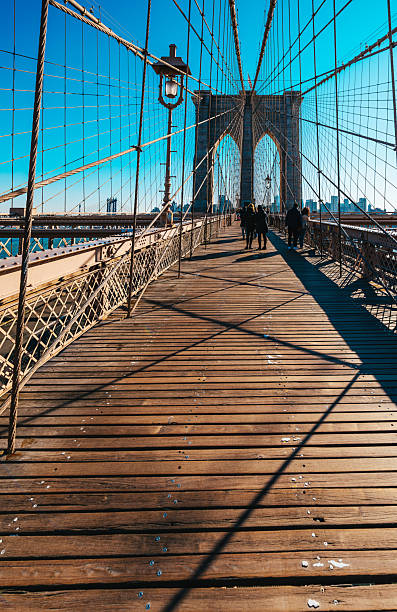 istock Brooklyn Bridge Walkway with Dramatic Shadows and City View in New York 2206696301