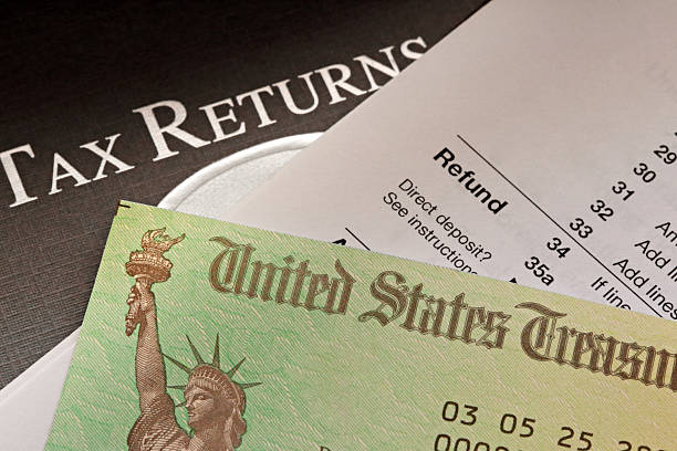 istock Tax Refund Check Resting On An IRS 1040 Tax Form 2206697364