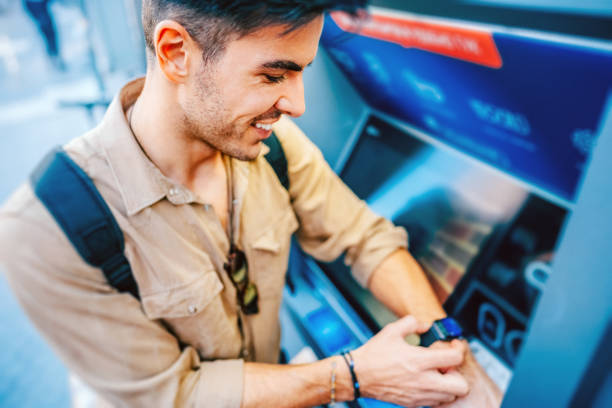 istock Man at the ATM withdrawing money with smart watch 2206698876