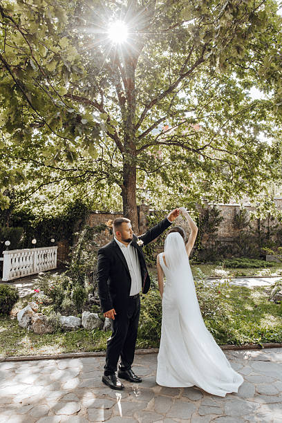 istock A bride and groom are dancing in front of a tree 2206699823