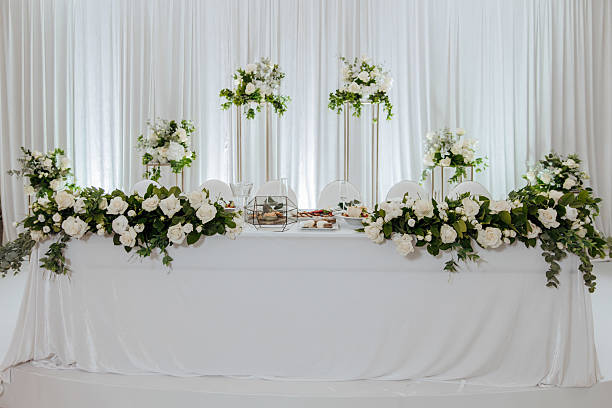 istock A table with white table cloth and white flowers on it 2206699835