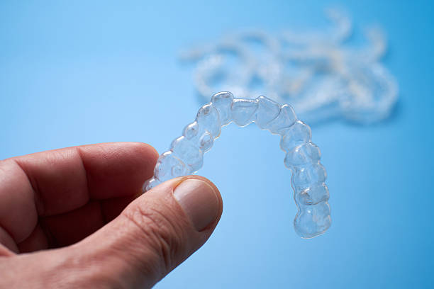 istock Clear Orthodontic Aligners Displayed on a Blue Surface During a Dental Treatment Session 2206699875