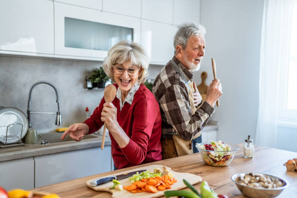 istock Playful senior couple singing in kitchen at home 2206700890