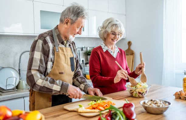 istock Senior couple making fresh healthy meal 2206701726