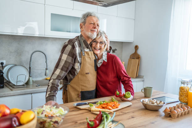 istock Senior couple preparing lunch together 2206701803