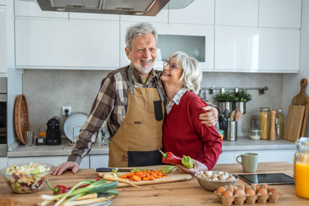 istock Senior couple preparing lunch together 2206701820
