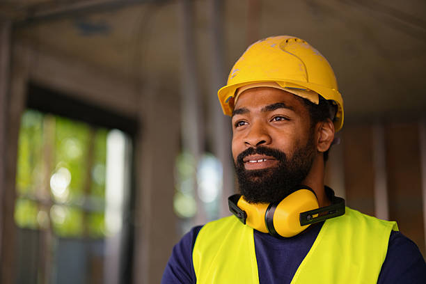 istock Confident Construction Worker Wearing Safety Gear at Workplace 2206703090