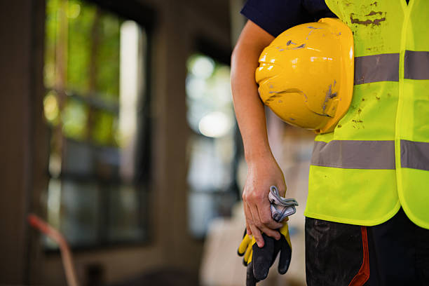 istock Construction Worker Holding Safety Gear in an Industrial Setting 2206703091