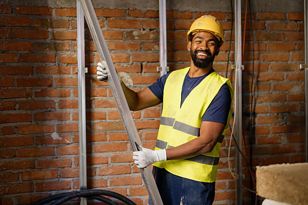 istock Smiling Construction Worker Holding Metal Beam on a Building Site 2206703128
