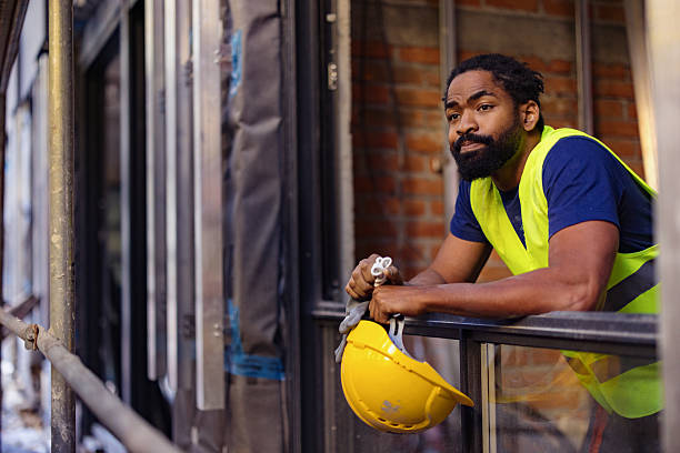 istock Construction Worker in Safety Vest Leaning on a Railing During Break 2206703135