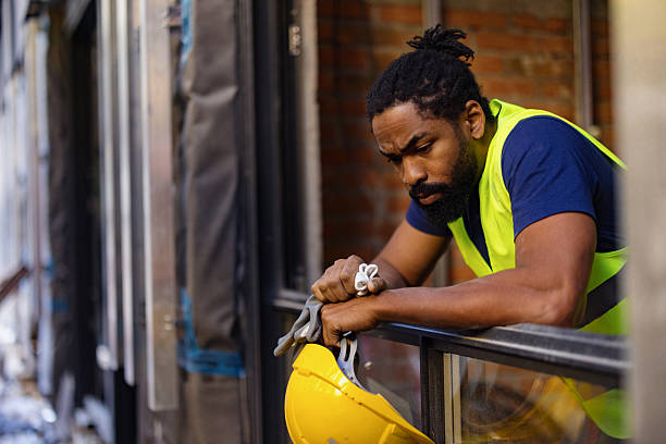 istock Construction Worker Reflecting Outdoors With Helmet and Safety Vest 2206703139