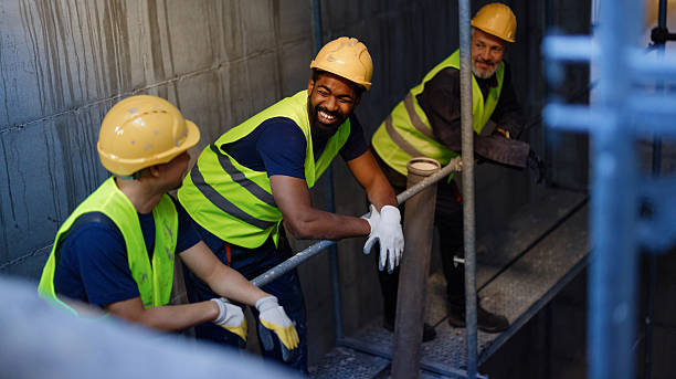 istock Group of Construction Workers Taking a Break and Enjoying Lighthearted Conversation 2206703161