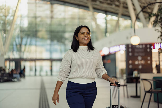 istock Confident Traveler Strolling Through a Modern Airport Hallway 2206706440