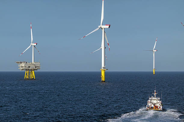istock Green Energy Journey: Passenger ship Moving Toward Offshore Wind farm. 2206707213