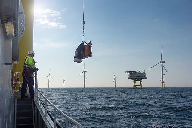 istock Offshore Worker Supervising Lift Operation – Wind Farm Deck View 2206707399