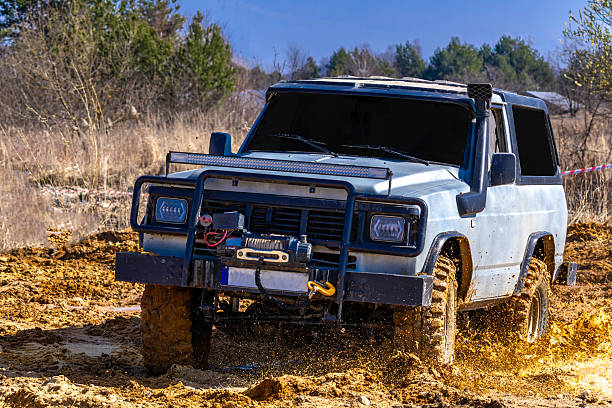 istock A large car adapted to driving in difficult terrain, overcoming mud, deep water during off-road 2206707538
