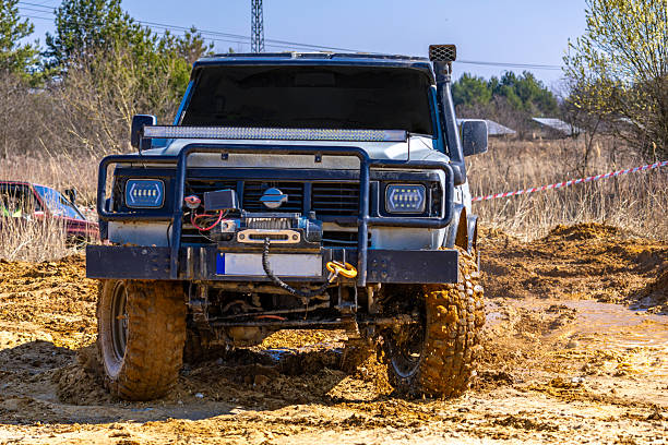 istock A large car adapted to driving in difficult terrain, overcoming mud, deep water during off-road 2206707706