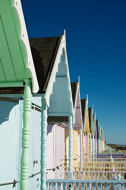 istock Colorful Beach Huts Along the Coast Under Clear Blue Sky Mersea 2206708426