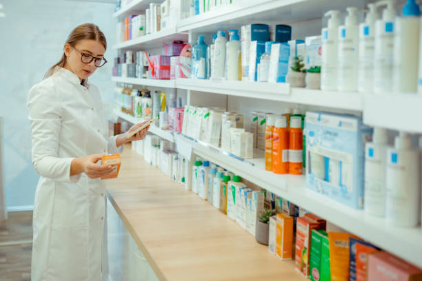 istock Professional Female Pharmacist Checking Inventory on a Digital Tablet 2206709415