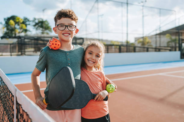 istock brother and sister playing pickleball together 2206712027
