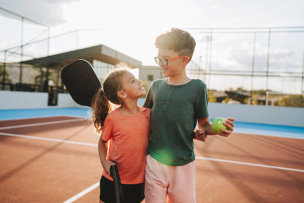 istock brother and sister playing pickleball together 2206712124