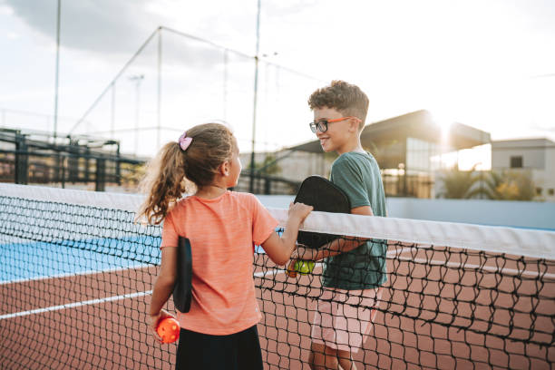 istock brother and sister playing pickleball together 2206712176