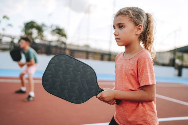 istock brother and sister playing pickleball together 2206712198