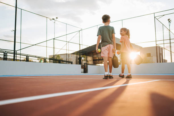 brother and sister playing pickleball together