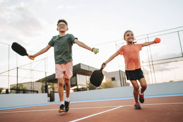 istock brother and sister playing pickleball together 2206712220