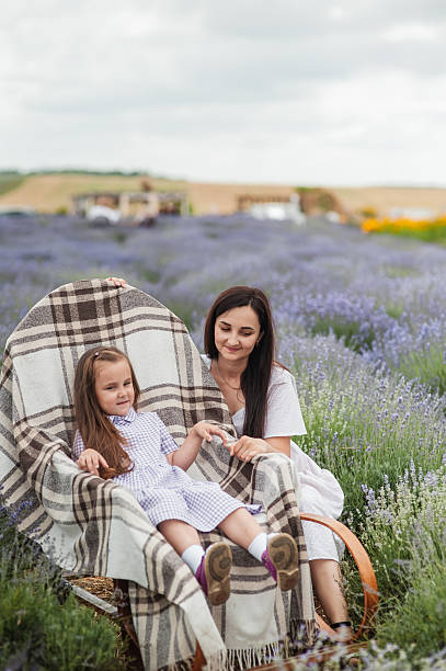 istock Beautifully dressed woman with child in lavender field 2206712849