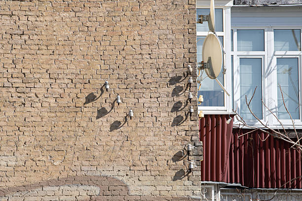 A photo showing tree shadows cast on the building facade at Kazanqi Folk-Custom Village. The dappled light creates a distinctive pattern that highlights the local architectural character and adds a culturally resonant touch to the structure.