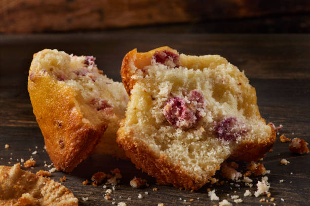 Top view of homemade delicious muffins and cranberry on blue wooden background. Copyspace.