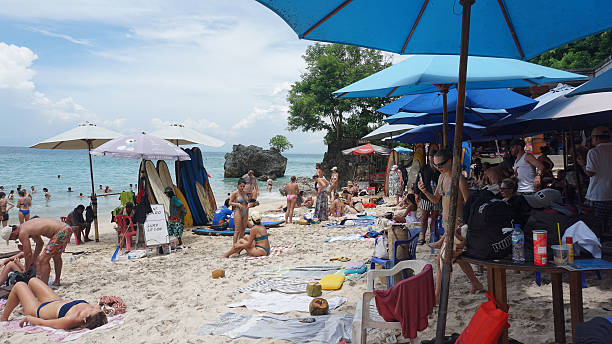 Bali, Indonesia - January 18, 2025: People resting at tropical beach Padang Padang in Bali at Indonesia