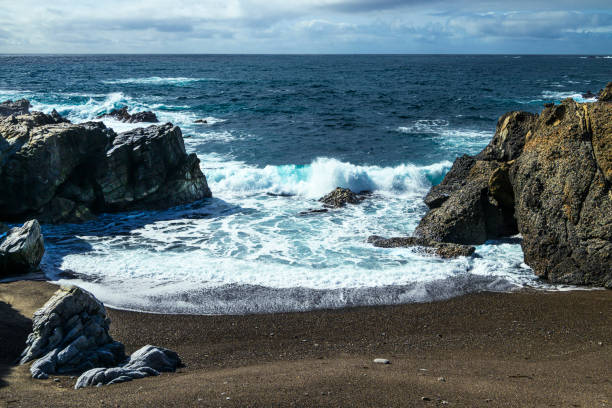 High angle view of rocky shore and crashing ocean waves along the Big Sur coast.Taken from Point Lobos Sate Park, California, USA