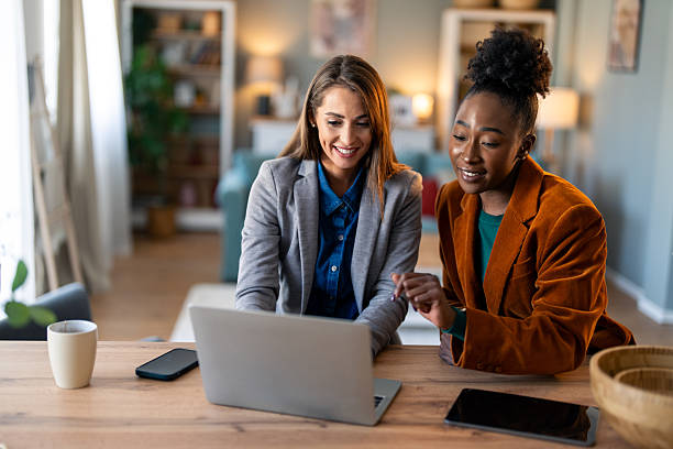 istock Two Diverse Women Collaborating Remotely in Cozy Home Office 2206722285