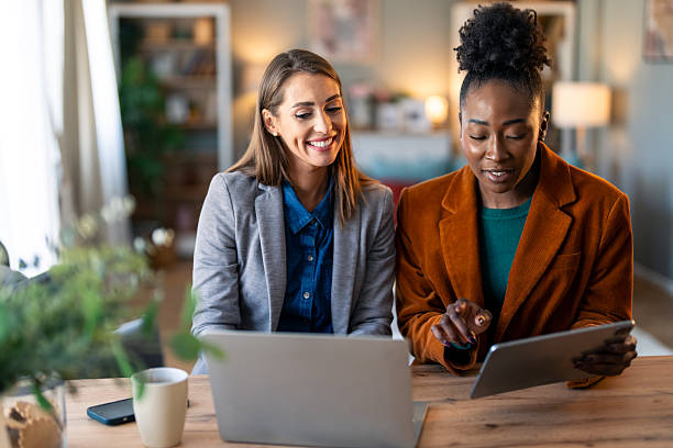 istock Young Female Entrepreneurs Collaborate on Digital Project at Home Office 2206722643