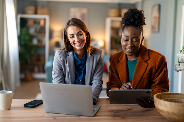 istock Two Diverse Women Collaborating in Bright Home Office 2206722645