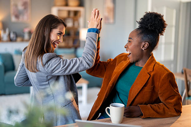 istock Two Professional Women Celebrating Success in Bright Home Office 2206722681