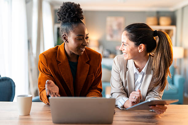 istock Professional Women Sharing Ideas In Sunlit Home Office Space 2206723089