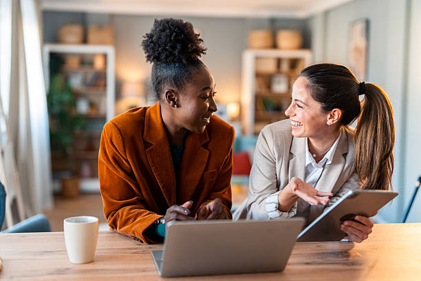 Diverse Business Partners Planning Strategy With Digital Devices At Home
