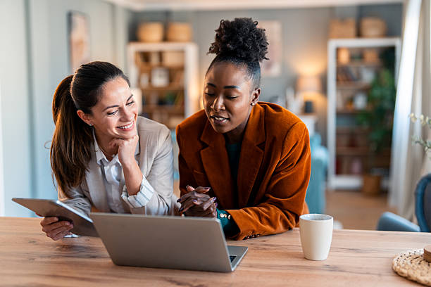 istock Two Professional Women Collaborating in a Bright Home Office 2206723096