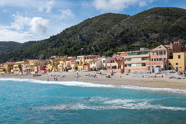 Varigotti, Italy - 2024, May 4 : People enjoying  a sunny day on the beach of Varigotti, a little town near Noli and Finale Ligure in the Liguria region of Italy