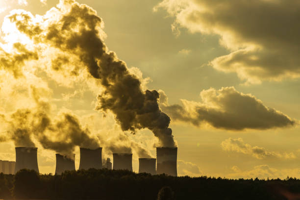 istock Industrial Plant Emitting Pollution into the Sunset Sky 2206724532