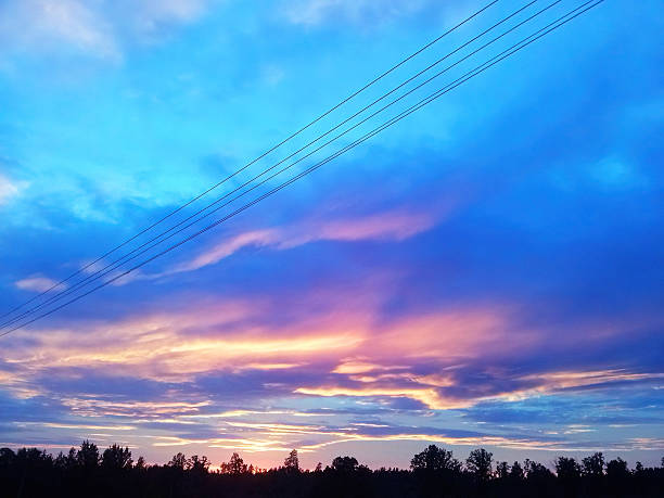 istock Fiery yellow pink blue summer evening sunset sky in a countryside 2206724579